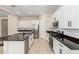 Well-equipped kitchen with modern stainless steel appliances, granite counters and white cabinets at 16860 W Soft Wind Dr, Surprise, AZ 85387