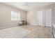 Bright living area features tile flooring, a large window, and neutral paint for a calm atmosphere at 16860 W Soft Wind Dr, Surprise, AZ 85387