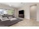 Open-concept living room with tile floors, a comfortable sectional sofa, and a sliding glass door at 16860 W Soft Wind Dr, Surprise, AZ 85387