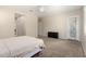 Bright main bedroom featuring a ceiling fan, carpeted floors, and a private patio door at 16860 W Soft Wind Dr, Surprise, AZ 85387