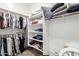 Organized walk-in closet with shelving and hanging storage for clothes and accessories at 16860 W Soft Wind Dr, Surprise, AZ 85387