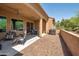 Covered backyard patio with outdoor furniture and a grill, perfect for entertaining at 16935 W Sheridan St, Goodyear, AZ 85395