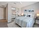 This is a bedroom with a mirrored closet and a soft palette with white, gray, and blue accents at 16935 W Sheridan St, Goodyear, AZ 85395