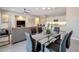 Open-concept dining area with modern decor, seamlessly connected to the living room and a sleek kitchen at 16935 W Sheridan St, Goodyear, AZ 85395