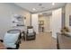 This home office offers a private workspace with a reading chair and bright natural light at 16935 W Sheridan St, Goodyear, AZ 85395