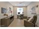 This home office features a desk, a reading nook, and decorative art for a comfortable work-from-home space at 16935 W Sheridan St, Goodyear, AZ 85395