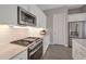 Modern kitchen featuring stainless steel appliances, white cabinetry, and sleek countertops at 16935 W Sheridan St, Goodyear, AZ 85395