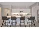 Bright, modern kitchen featuring a large central island with barstool seating and pendant lighting above at 16935 W Sheridan St, Goodyear, AZ 85395