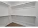 A walk-in closet featuring neutral walls and flooring, with shelving around the entire perimeter at 16935 W Sheridan St, Goodyear, AZ 85395