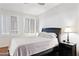 Bedroom featuring shuttered windows, a ceiling fan, and wood floors at 1701 E Colter St # 443, Phoenix, AZ 85016