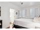 Bright bedroom with white walls, wood floors, and a view to the ensuite bathroom at 1701 E Colter St # 443, Phoenix, AZ 85016