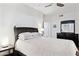 A bedroom featuring a ceiling fan, ensuite bath, and dark wood furniture at 1701 E Colter St # 443, Phoenix, AZ 85016
