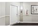 Hallway entrance to unit 443 with white door, fire extinguisher, and framed artwork at 1701 E Colter St # 443, Phoenix, AZ 85016