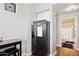 Kitchen featuring stainless steel refrigerator and access to a well-lit bathroom at 1701 E Colter St # 443, Phoenix, AZ 85016