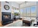 Bright living room features a cozy fireplace, plantation shutters, and a plush rug at 1701 E Colter St # 443, Phoenix, AZ 85016