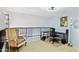 Upstairs loft space with tan carpeting, black railing, desk, and chair at 1701 E Colter St # 443, Phoenix, AZ 85016
