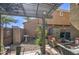 Backyard patio features comfortable seating, shade cover, desert landscaping, and stone flooring at 1786 S Seton Ave, Gilbert, AZ 85295