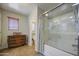 Clean bathroom featuring a glass enclosed shower-tub, vanity, and stylish decor at 1786 S Seton Ave, Gilbert, AZ 85295