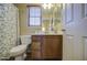 Well-lit bathroom boasts wood cabinets, decorative shower curtain and window with wood blind at 1786 S Seton Ave, Gilbert, AZ 85295