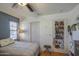 Cozy bedroom featuring wood blinds, a ceiling fan, and closet with sliding doors at 1786 S Seton Ave, Gilbert, AZ 85295