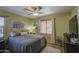 Comfortable bedroom with a ceiling fan, natural light, and neutral-toned bedding at 1786 S Seton Ave, Gilbert, AZ 85295