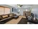 Inviting living space with a large leather sofa, ceiling fan, and a dedicated workspace at 1786 S Seton Ave, Gilbert, AZ 85295