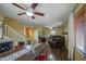 Cozy living room featuring hardwood floors, ceiling fan, open plan, and natural light at 1786 S Seton Ave, Gilbert, AZ 85295