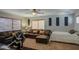 Cozy living room featuring a leather sofa, ceiling fan, and natural light from the window at 1786 S Seton Ave, Gilbert, AZ 85295