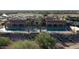 Community's aerial view showcasing beautiful pools, a clubhouse and surrounding desert landscape at 22508 W Antelope Trl, Buckeye, AZ 85326