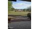 Private back patio overlooking a green golf course with mountain views and mature landscaping at 22508 W Antelope Trl, Buckeye, AZ 85326