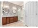 Bathroom showcasing dual sinks, decorative wall, and glass-enclosed shower at 22508 W Antelope Trl, Buckeye, AZ 85326