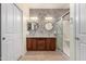 Elegant bathroom with dual sinks, decorative wall, and glass-enclosed shower at 22508 W Antelope Trl, Buckeye, AZ 85326