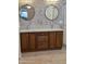 Bathroom featuring dual sinks with granite countertops and a tile backsplash design at 22508 W Antelope Trl, Buckeye, AZ 85326