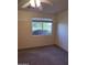 Bedroom with tan carpet and a window with an outdoor view at 22508 W Antelope Trl, Buckeye, AZ 85326