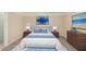 Cozy bedroom featuring neutral decor, side tables with lamps, and elegant artwork for a serene atmosphere at 22508 W Antelope Trl, Buckeye, AZ 85326