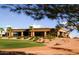 Stunning architecture of the clubhouse, surrounded by well-manicured landscaping and desert scenery at 22508 W Antelope Trl, Buckeye, AZ 85326