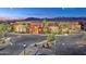 Beautiful exterior view of the clubhouse, featuring desert landscaping, palm trees, and mountain views at 22508 W Antelope Trl, Buckeye, AZ 85326