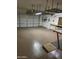 Garage with an epoxy floor, overhead storage racks, and workbench at 22508 W Antelope Trl, Buckeye, AZ 85326