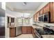 Stylish kitchen featuring granite countertops, stainless steel appliances, and wood cabinets at 22508 W Antelope Trl, Buckeye, AZ 85326