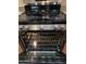 The kitchen showcases a stainless steel oven with an open door, complemented by a sleek stovetop and cabinetry at 22508 W Antelope Trl, Buckeye, AZ 85326