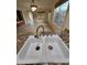 Bright kitchen featuring a stainless steel sink, granite counters, and an open layout to the living area at 22508 W Antelope Trl, Buckeye, AZ 85326