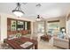 Open concept living room featuring a built in media center and furniture including a wood dining table at 22508 W Antelope Trl, Buckeye, AZ 85326