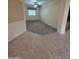 The versatile living room features carpet and ample natural light, seamlessly blending into the tiled hallway at 22508 W Antelope Trl, Buckeye, AZ 85326