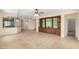 This spacious living room boasts an entertainment center and sleek tile floors at 22508 W Antelope Trl, Buckeye, AZ 85326