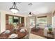 Open concept living room featuring a built in media center and furniture including an elaborate table setting at 22508 W Antelope Trl, Buckeye, AZ 85326