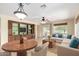 Open concept living room featuring a built in media center, ceiling fan, and large window overlooking the backyard at 22508 W Antelope Trl, Buckeye, AZ 85326