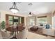 Open concept living room featuring a built in media center and furniture including a round wood dining table at 22508 W Antelope Trl, Buckeye, AZ 85326