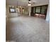 Spacious living room with tile flooring, ceiling fan, recessed lighting, and a large built-in entertainment center at 22508 W Antelope Trl, Buckeye, AZ 85326