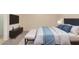 Comfortable bedroom with a TV, dark wood cabinet, and white cushioned bench at the foot of the king size bed at 22508 W Antelope Trl, Buckeye, AZ 85326
