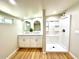 Bright bathroom with a dual vanity, modern fixtures, and a walk-in shower at 2258 E Alpine Ave, Mesa, AZ 85204